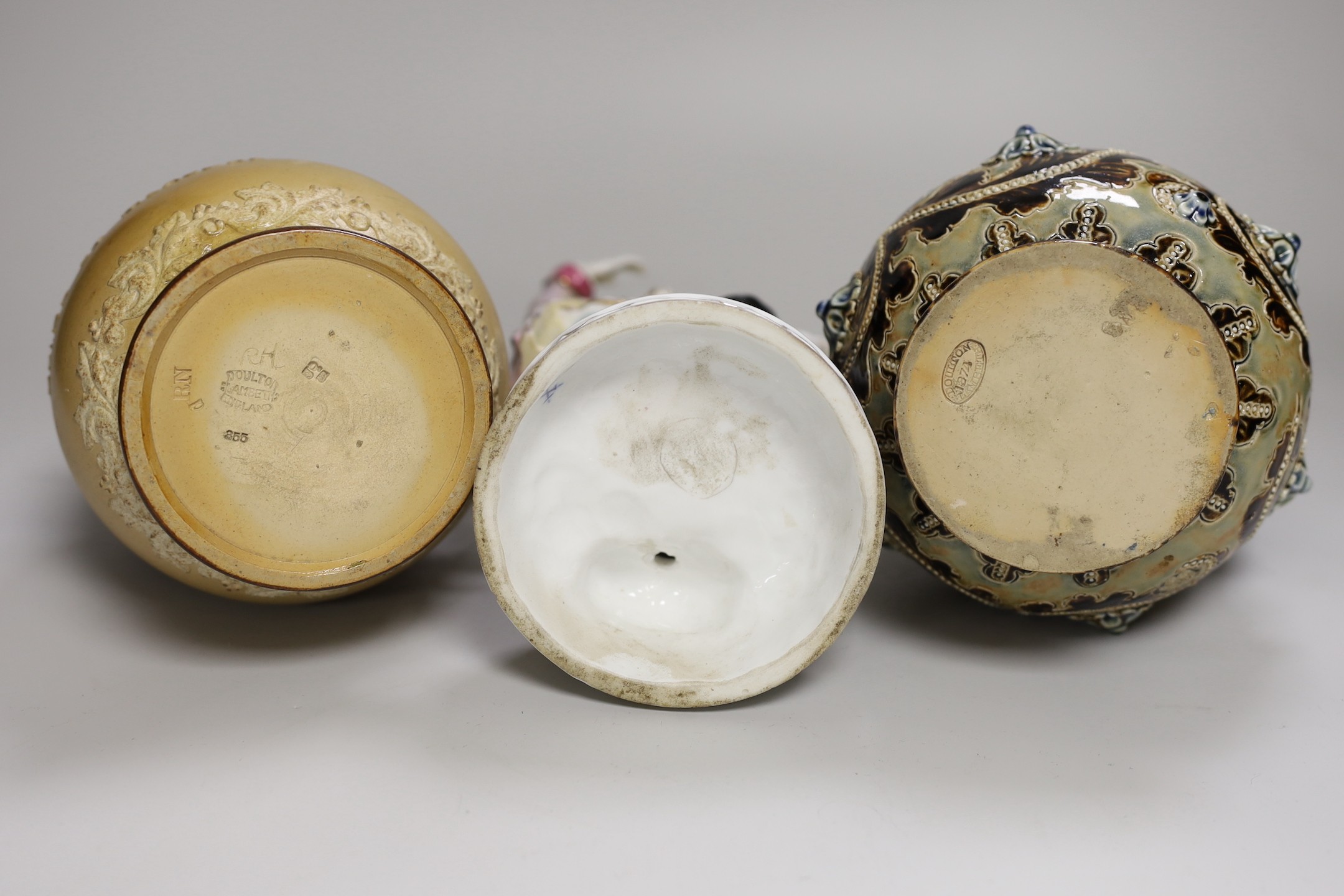 A group of six Doulton Lambeth stoneware vessels, tallest 22.5 cm and a French porcelain figure of a gentleman (7)